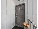Condo front door adorned with seasonal flowers on a small landing at 1000 S Semoran Blvd # 604, Winter Park, FL 32792