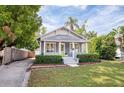 Quaint single-story home boasting a lush lawn and a welcoming front porch with a bright green door at 112 E Spruce St, Orlando, FL 32804