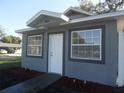 Inviting home entrance with a white front door, decorative plants, and ample natural light at 1600 Roosevelt Ave, Orlando, FL 32804