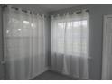 Bright living room with new gray vinyl flooring, white trim, and sheer curtains at 1600 Roosevelt Ave, Orlando, FL 32804