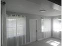 Bright living room with new gray vinyl flooring, white trim, and sheer curtains at 1600 Roosevelt Ave, Orlando, FL 32804