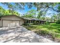 Side view of house showing detached garage and mature landscaping at 220 Morton Ln, Winter Springs, FL 32708