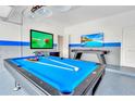 Bright game room featuring a pool table, foosball table, and two large screen TVs at 2496 Rama Dr, Kissimmee, FL 34746
