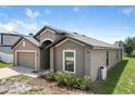 Attractive single-Gathering home with a long driveway and manicured landscaping at 257 Fig Ct, Kissimmee, FL 34759