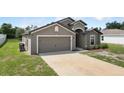 Beautiful home showcasing its attached two-car garage and well-maintained lawn at 257 Fig Ct, Kissimmee, FL 34759