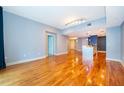 Bright living room with wood floors leading to a modern open kitchen at 260 S Osceola Ave # 710, Orlando, FL 32801