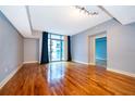 Spacious living room featuring a balcony, wood floors, and neutral paint at 260 S Osceola Ave # 710, Orlando, FL 32801