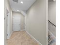 Hallway features neutral walls, access to multiple rooms, as well as a staircase to the upper level of the home at 2704 Lobelia Dr, Lake Mary, FL 32746