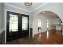Spacious entryway with tile flooring and double doors, leading to the living area with hardwood floors at 300 Royal Palm Ct, Longwood, FL 32779