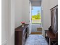 Inviting foyer featuring stylish decor, a convenient bench, and a view of the outdoors at 3123 Camden Way, Davenport, FL 33837