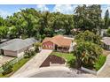 Aerial view of a cozy home nestled among mature trees in a quiet residential neighborhood at 3511 Superior Ct, Orlando, FL 32810