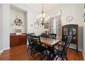 Traditional dining room with wood floors, chandelier, and ample natural light at 3753 Heirloom Rose Pl, Oviedo, FL 32766