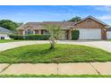 Charming one-story brick home with a manicured lawn and driveway at 40 Hollow Pine Dr, Debary, FL 32713
