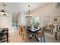 Bright dining room with tile floors, six chairs and a modern chandelier at 411 Evening Sky Dr, Oviedo, FL 32765