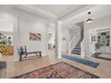 Bright foyer with tile flooring, decorative rug, and staircase leading to the second floor at 4221 Isle Vista Ave, Belle Isle, FL 32812