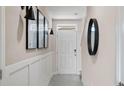 Elegant entryway with modern lighting fixtures, wainscoting, and contemporary decor at 4618 Linda Dr, Lake Wales, FL 33859