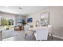Elegant dining area with a white table set for four, bathed in natural light at 4622 Linda Dr, Lake Wales, FL 33859