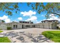 Stunning home with a spacious paver driveway, manicured lawn, and three-car garage at 49 Interlaken Rd, Orlando, FL 32804