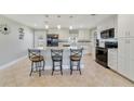 Bright and spacious kitchen with white cabinets, granite countertops, and modern appliances at 5984 Ed Harris Ct, St Cloud, FL 34771