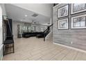 Spacious living room with tile floors, a staircase, and ample natural light, perfect for gatherings and relaxation at 672 Seven Oaks Blvd, Winter Springs, FL 32708