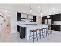 Stylish kitchen features sleek, modern cabinetry, stainless steel appliances, a large island with bar seating, and pendant lighting at 744 Curly Locks Loop, Apopka, FL 32703