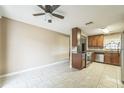 Open kitchen with tile floors, stainless steel appliances, and wood cabinets at 8040 Sagebrush Pl, Orlando, FL 32822