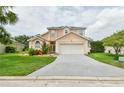 Charming two-story home featuring a well-maintained lawn and a two-car garage for convenience at 831 Corvina Dr, Davenport, FL 33897