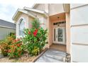 Close-up of the front door and landscaped entry, adding to the home's curb appeal at 831 Corvina Dr, Davenport, FL 33897