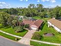 Inviting single-story home with lush landscaping, brick accents, and a neatly paved driveway at 9326 Bay Vista Estates Blvd, Orlando, FL 32836