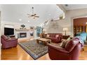 Spacious living room with a fireplace, hardwood floors, and an open layout at 9326 Bay Vista Estates Blvd, Orlando, FL 32836