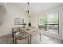Dining room with large window, modern light fixture, and neutral decor at 940 Douglas Ave # 132, Altamonte Springs, FL 32714