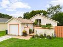Charming single-story home with attached garage and an inviting, landscaped entryway at 9814 Piney Point Cir, Orlando, FL 32825