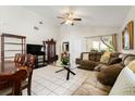 Inviting living room featuring vaulted ceiling, tile floors and comfortable seating arrangements at 9814 Piney Point Cir, Orlando, FL 32825