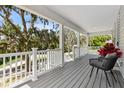 Spacious front porch with ample seating, scenic views, and durable composite flooring at 1031 Morningside Dr, Eustis, FL 32726