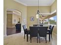Cozy dining area with stylish black chairs and a view to the outdoor covered lanai at 12663 Hawkstone Dr, Windermere, FL 34786
