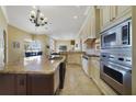 Bright kitchen showcases stainless steel appliances, granite counters, and seamless flow to other rooms at 12663 Hawkstone Dr, Windermere, FL 34786