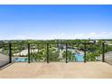Scenic view from balcony showcasing a pool and community amenities under a bright blue sky at 13618 Heaney Ave, Orlando, FL 32827