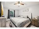 Cozy bedroom with wood-look flooring, a ceiling fan, and ample natural light at 14565 Lycastle Cir, Orlando, FL 32826