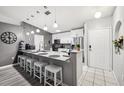 Modern kitchen features a granite countertop island and stainless steel appliances at 14565 Lycastle Cir, Orlando, FL 32826