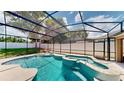 Relaxing pool with spa surrounded by a screen enclosure for year-round enjoyment at 14723 Pine Cone Trl, Clermont, FL 34711