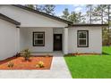 Inviting front entrance with mulched landscaping, creating a welcoming atmosphere to the home at 17485 Sw 41St Cir, Ocala, FL 34473