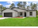 Charming one-story home with a well-manicured lawn and beautiful landscaping adds to the curb appeal at 17485 Sw 41St Cir, Ocala, FL 34473
