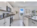 Well-lit kitchen with stainless steel appliances and granite countertops, ideal for cooking at 1854 Juneberry St, Clermont, FL 34715