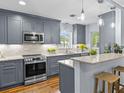 Beautiful kitchen with granite countertops, stainless steel appliances, and stylish gray cabinets at 2244 Brookshire Ave, Winter Park, FL 32792