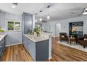 Open kitchen layout with granite countertops, wood floors and a view into the living area at 2244 Brookshire Ave, Winter Park, FL 32792