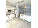 Efficient kitchen features white appliances, tile countertops, and ample cabinet space at 2524 Daffadil Ter, Sanford, FL 32771