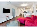 Spacious living room with hardwood floors, an open floor plan, and plenty of natural light at 2901 Edenshire Way # 102, Kissimmee, FL 34746