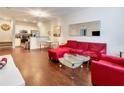 Bright, open living area featuring hardwood floors and an open flow to the kitchen at 2901 Edenshire Way # 102, Kissimmee, FL 34746