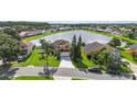 Scenic aerial view of a home with a lake, showcasing its beautiful setting at 344 Blue Bayou Dr, Kissimmee, FL 34743