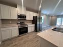 Modern kitchen with stainless steel appliances, sleek countertops, and ample cabinet space at 3950 Alba Dr, Indian Lake Estates, FL 33855